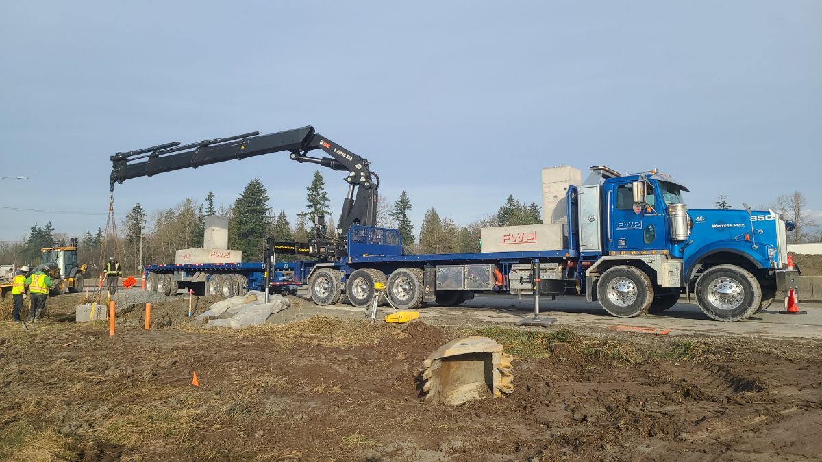 A Fraserway Prekast truck-mounted crane unloading precast elements on a civil site