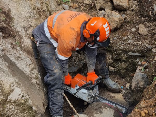A Direct Drains crew working an open drainage trench